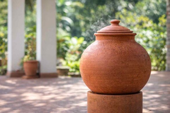 Clay water pot (matka) on a shaded porch, showing natural cooling.