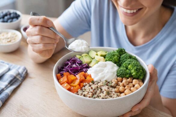 smiling person prepping a high-fiber bowl with colorful veggies and yogurt
